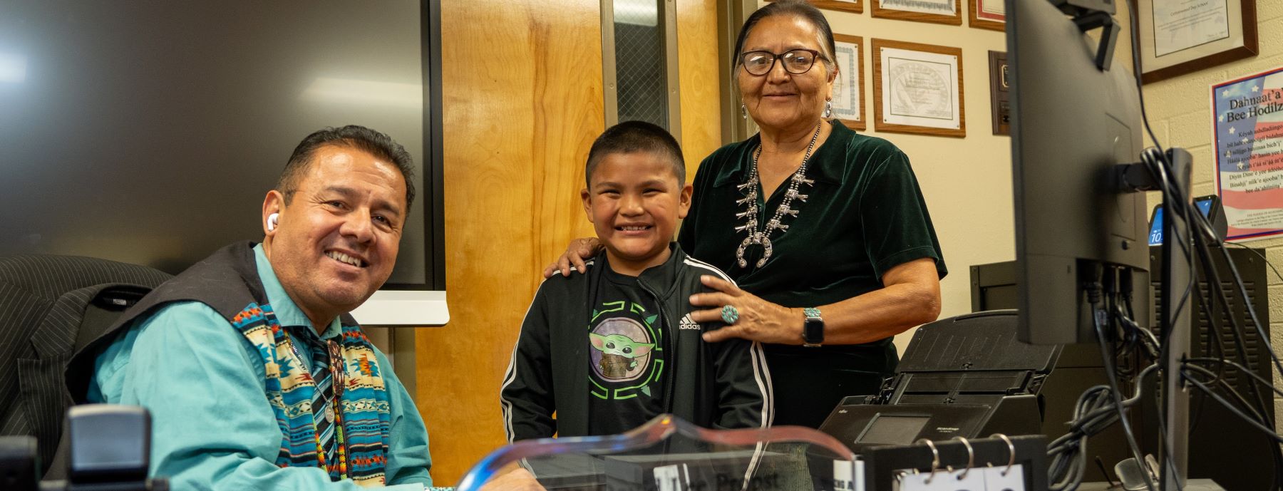 Principal student and adult in school office.
